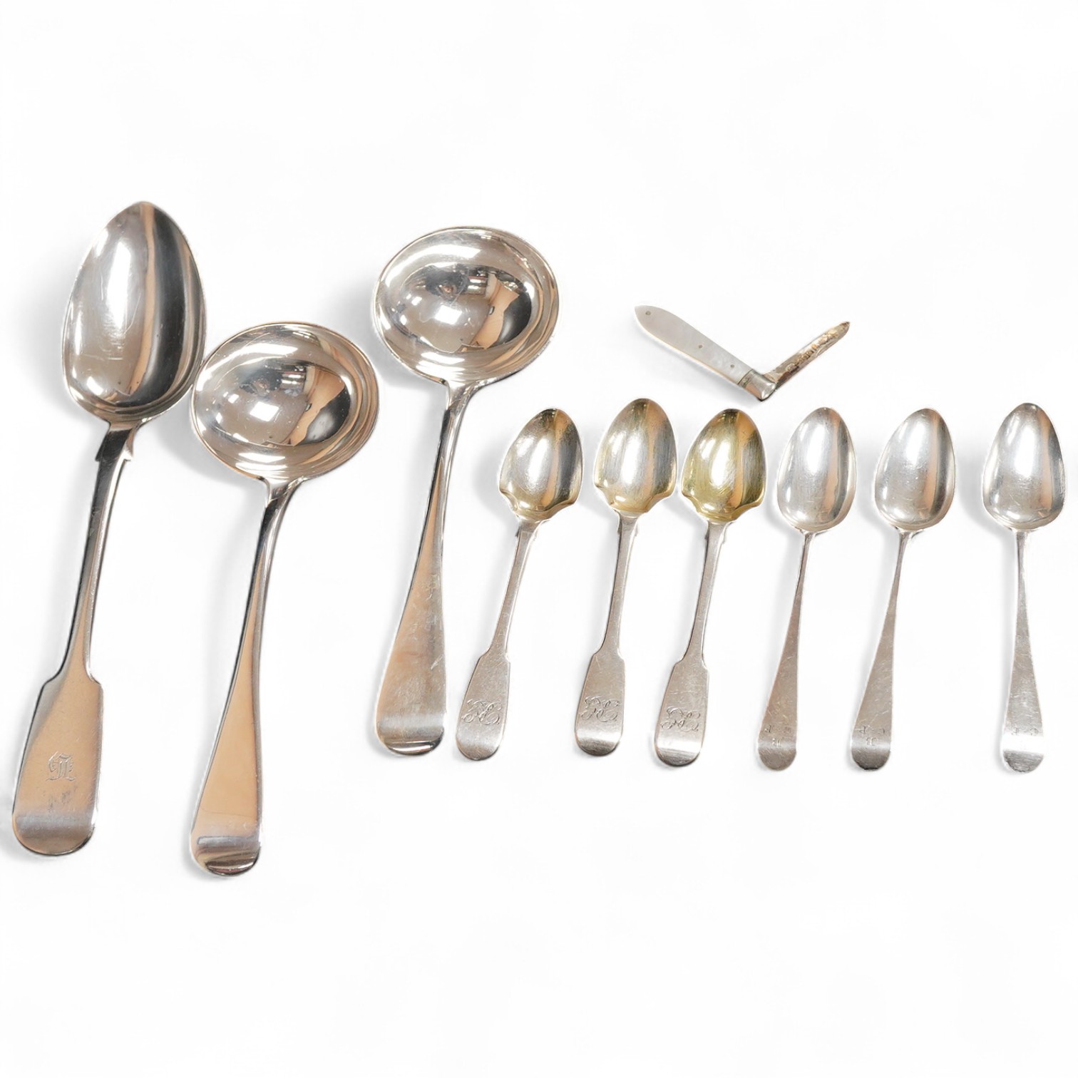 A pair of Edwardian silver Old English pattern sauce ladles, by Daniel & John Welby, London, 1901, 17.3cm, together with seven other items of silver flatware including a fiddle pattern table spoon, London, 1845 and a mot